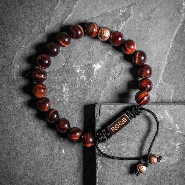 Premium Red Tiger Eye Bead Bracelet - Our Premium Red Tiger Eye Bead Bracelet Features Natural Stones, Waxed Cord and Polished Rose Gold Steel Hardware. A Beautiful Addition to any Collection.